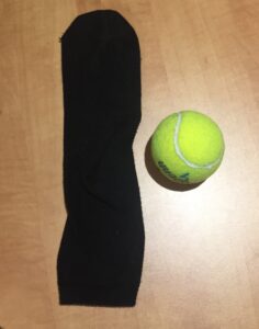 An Anke length sock and a tennis ball